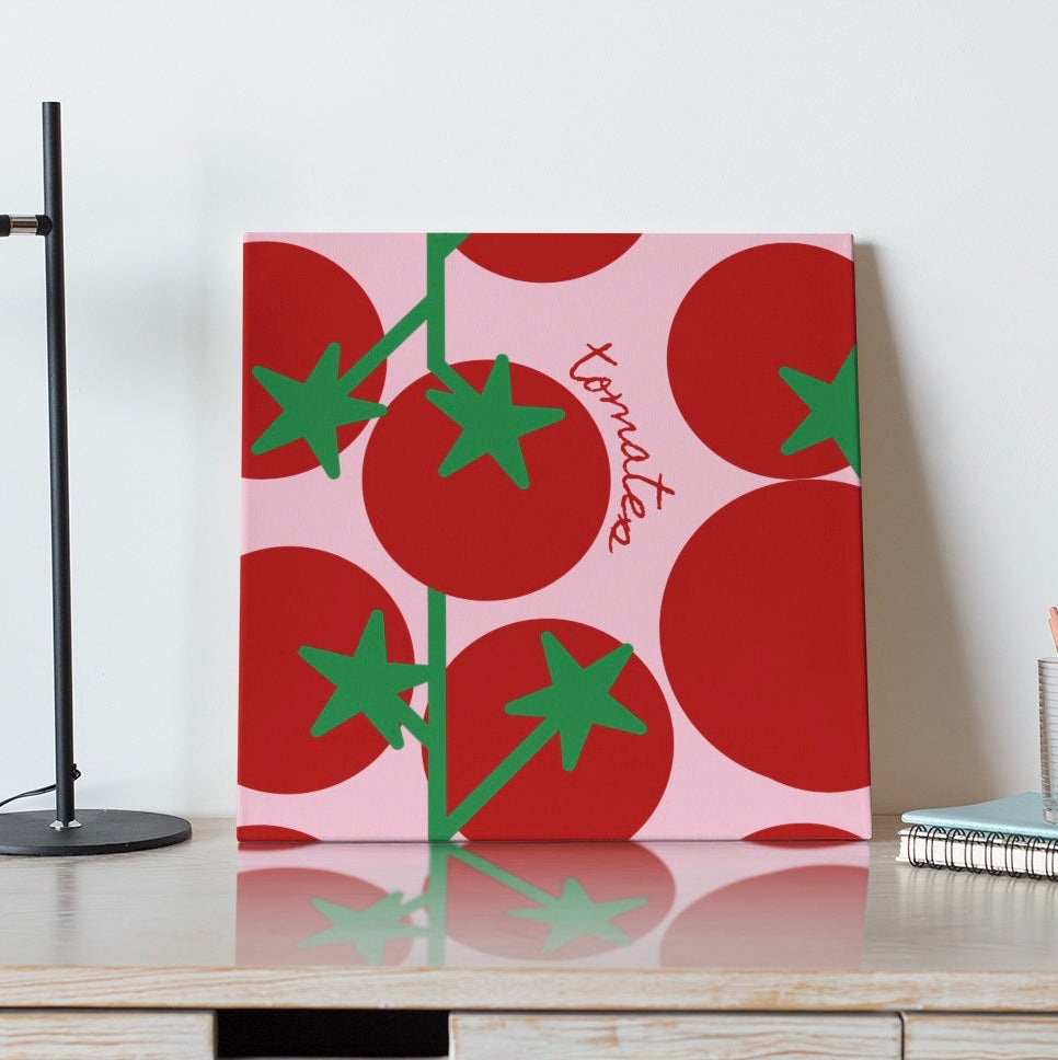 Decorative wall art with tomato design on a white wall above a wooden shelf.