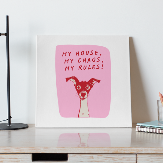 Desk with a framed print of a dog and text, lamp, and coffee cup.